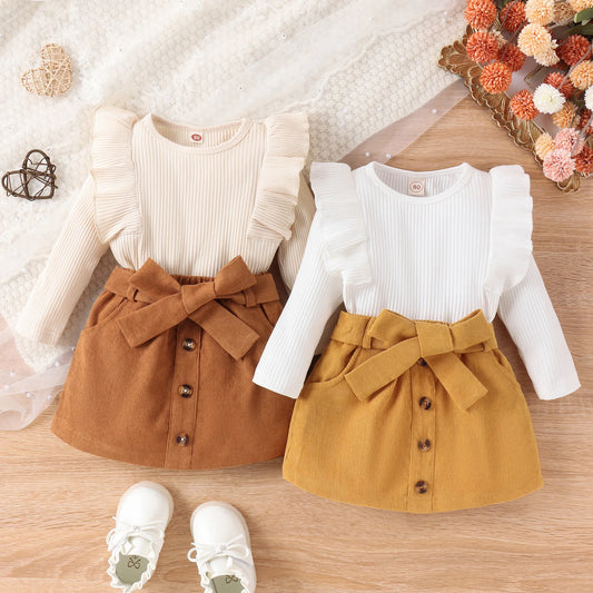 Toddler girls' autumn/winter clothing set includes a long-sleeve ruffle ribbed pullover and a solid button skirt.